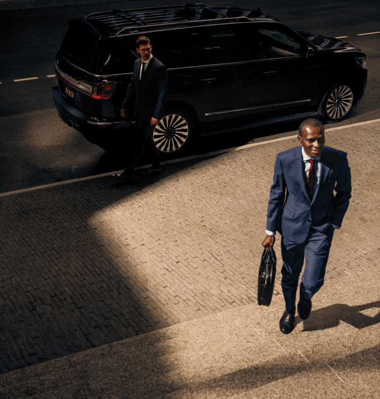 Chauffeur walking back to the driver seat while rider walks away